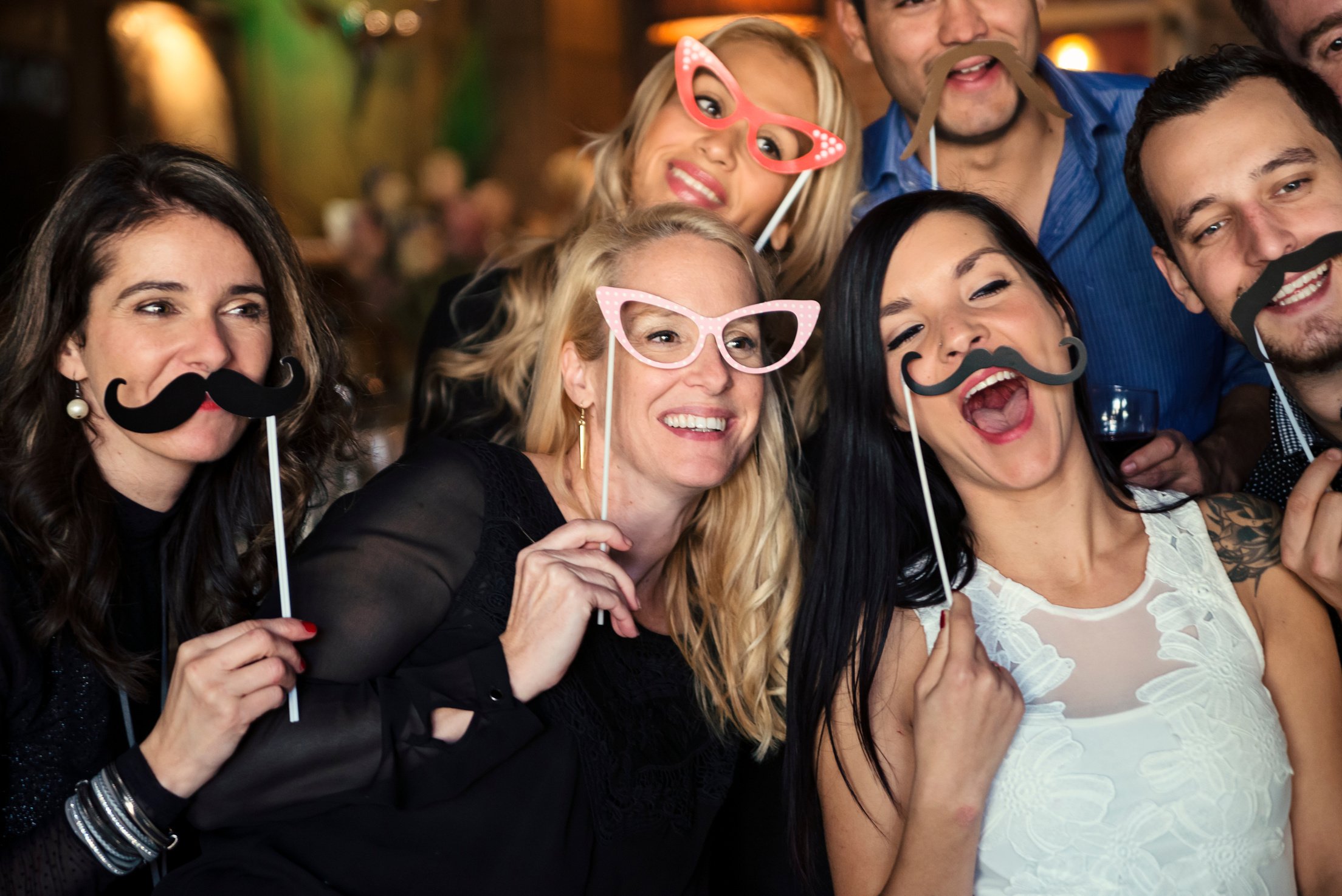 Friends and coworkers photo booth at a party in a bar.