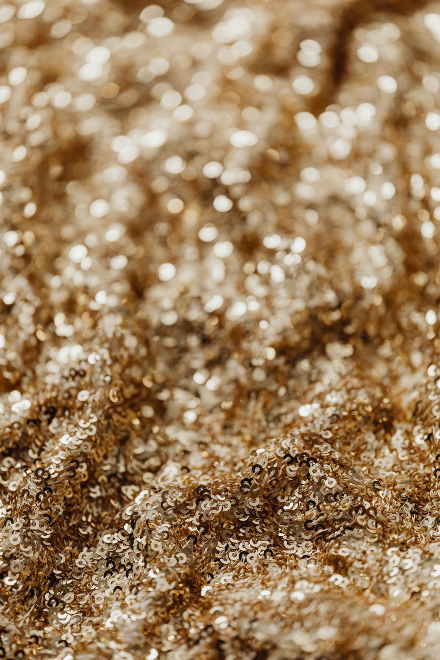 Selective Focus Photo of Gold Sequins